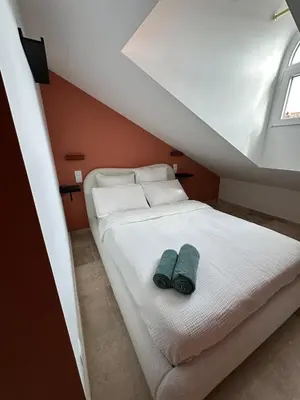 a bedroom with a bed with two towels on it at Le Notre Dame in Nice