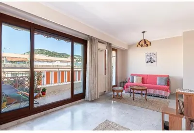 a living room with a red couch and a balcony at Absea Nice Port 2 in Nice