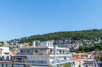 a large white building on top of a city at Absea Nice Port 2 in Nice