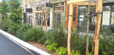 a garden in front of a building with plants at Appartements Massena in Nice