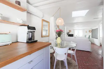 a kitchen with a table and a dining room at Le Collet - appt climatisé proche plage in Nice
