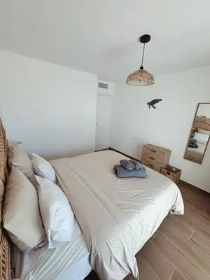 a bedroom with a bed with a towel on it at L'Odyssée in Saint-Laurent-du-Var