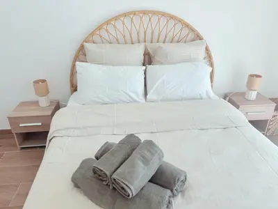 a bedroom with a bed with towels on it at L'Odyssée in Saint-Laurent-du-Var