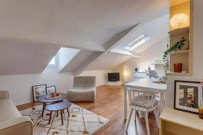 a living room with a couch and a table at ATTIC URBAN AP4485 by Riviera Holiday Homes in Nice