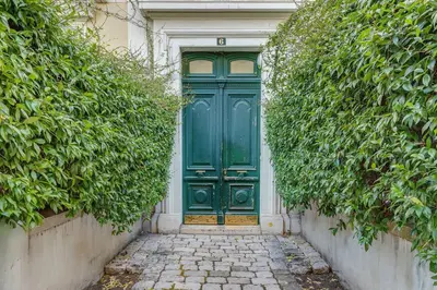 a green door with a stone path in front of it at ATTIC URBAN AP4485 by Riviera Holiday Homes in Nice