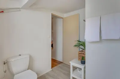 a bathroom with a white toilet in a room at ATTIC URBAN AP4485 by Riviera Holiday Homes in Nice