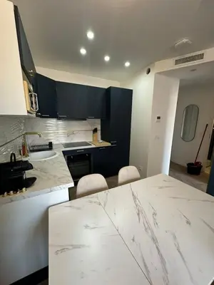 a kitchen with a large marble counter top in a room at MOON 41 - Appartement Nice 4P in Nice
