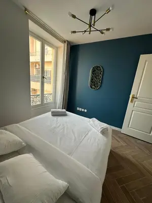a bedroom with a large white bed and a window at MOON 41 - Appartement Nice 4P in Nice