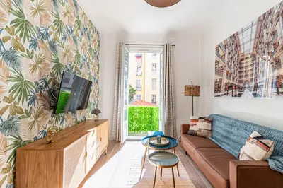 a living room with a couch and a tv at New Cosy Apartment Libération in Nice
