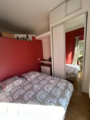 a bedroom with a bed and a mirror at 2 pièces avec balcon au port de Nice in Nice