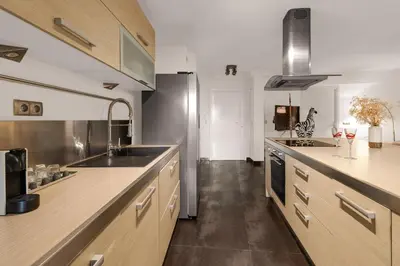 a large kitchen with a sink and a stove at Havre de Paix Mont Boron Proche du Port in Nice