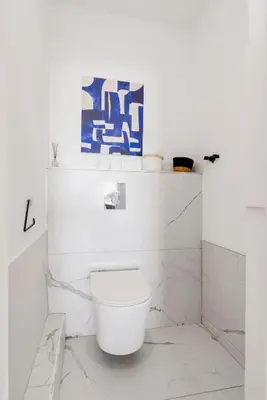 a white bathroom with a white toilet in it at Nice Renting - CARNOT - Escape to French Riviera Terrace with Sea View in Nice