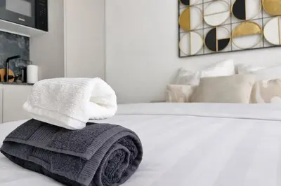 a pile of towels sitting on top of a bed at Studio sur la promenade des anglais in Nice