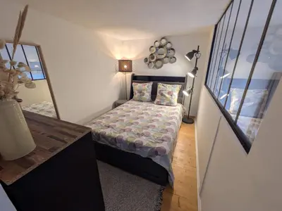 a small bedroom with a bed and a mirror at Palais des arts in Nice