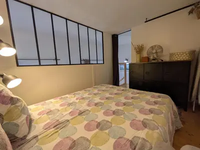 a bedroom with a bed and a large window at Palais des arts in Nice