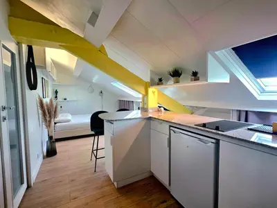 a kitchen with a sink and a room with a bed at Mansarde Lumineuse - Nice Gare 2 pers in Nice