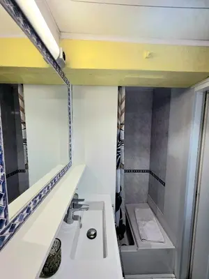 a bathroom with a sink and a mirror at Mansarde Lumineuse - Nice Gare 2 pers in Nice