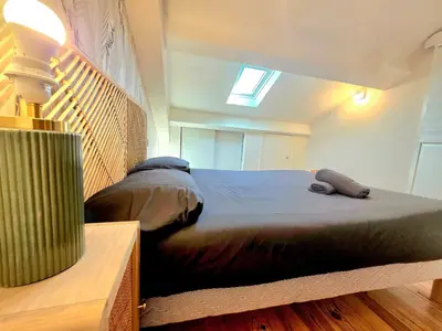 a bedroom with a large bed with a skylight at Design et confort - Nice Centre 4 pers in Nice