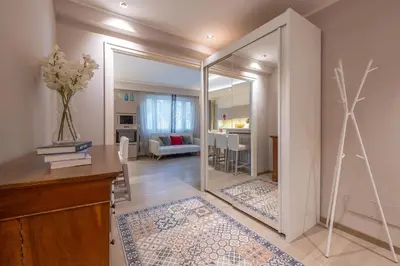 a room with a mirror and a living room at chloe in Beaulieu-sur-Mer