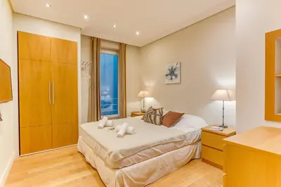 a bedroom with a bed and a large window at VUE MAGENTA AP4484 by Riviera Holiday Homes in Nice