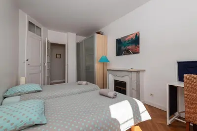 a bedroom with two beds and a fireplace at 