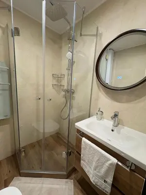 a bathroom with a shower and a sink and a mirror at Perle au Port de NICE in Nice