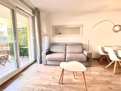 a living room with a couch and a table at Peaceful apartment in Nice with terrace, parking in Nice