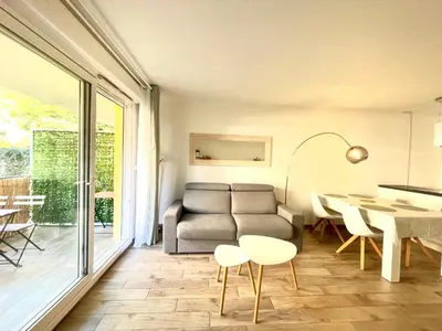 a living room with a couch and a table at Peaceful apartment in Nice with terrace, parking in Nice