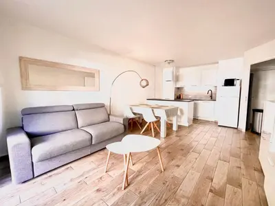 a living room with a couch and a table at Peaceful apartment in Nice with terrace, parking in Nice