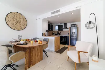 a kitchen and living room with a table and chairs at MY CASA - PALAIS MED 702 D - 2 bedroom Down Town with Terasse AC in Nice