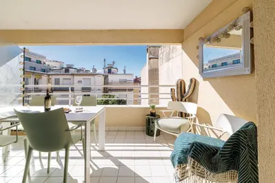 a balcony with a table and chairs and a window at MY CASA - PALAIS MED 702 D - 2 bedroom Down Town with Terasse AC in Nice
