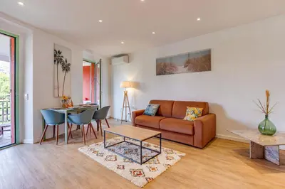 a living room with a couch and a table at NID MASSENA AP4486 by RIVIERA HOLIDAY HOMES in Nice