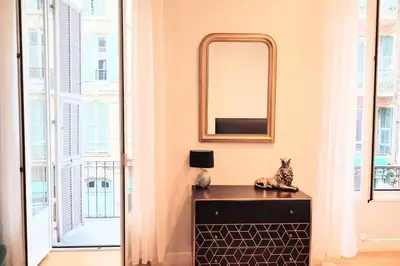 a mirror above a dresser in a room with windows at Studio in the heart of Nice close to amenities in Nice