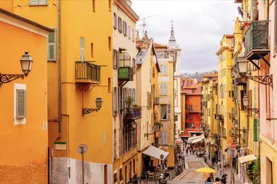 a street in an old town with yellow buildings at Stella Monte 1 AC WiFi 4 Pers in Nice