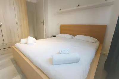 a bedroom with a white bed with two towels on it at Stella Monte 1 AC WiFi 4 Pers in Nice