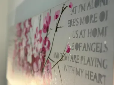 a sign with pink flowers on a wall at Au cœur du Vieux Nice, superbe studio refait à neuf in Nice