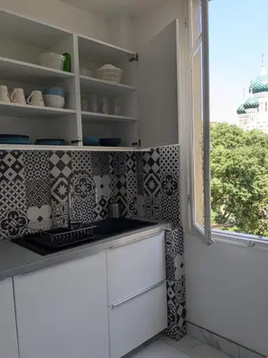 a kitchen with white cabinets and a window at Joli appartement central, tout équipé & proche gare in Nice