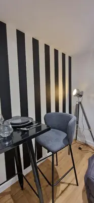 a dining room with a table and a chair at Charmant studio sur la Promenade des Anglais in Nice