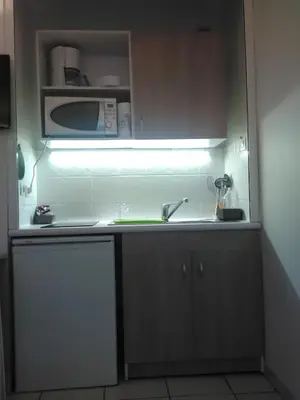 a kitchen with a sink and a microwave at Californie Appartement in Nice