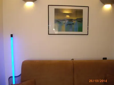 a living room with a couch and a blue light at Californie Appartement in Nice