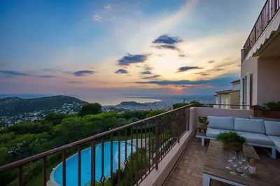 a balcony with a view of a swimming pool at Appartment - Panoramic Sea View - Swimming Pool in Villefranche-sur-Mer