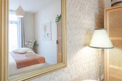 a bedroom with a mirror on the wall at L10 Suite Clemenceau Central, next train station in Nice