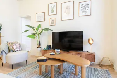a living room with a coffee table and a tv at L10 Suite Clemenceau Central, next train station in Nice