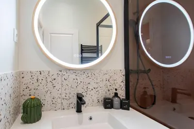 a bathroom with a sink and a mirror at L10 Suite Clemenceau Central, next train station in Nice