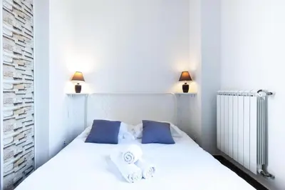 a bedroom with a white bed with towels on it at Modern & Central Apartment in Nice