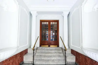 a staircase leading to a wooden door in a building at Modern & Central Apartment in Nice