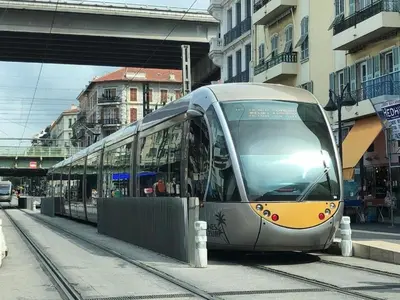 a train on the tracks in a city at Modern & Central Apartment in Nice
