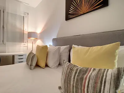 a bedroom with a bed with yellow and white pillows at Nestor&Jeeves - BEETHOVEN - Residential Area - Central in Nice
