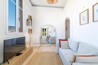 a living room with a couch and a tv at Cozy and bright appartement - Port of Nice in Nice