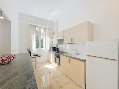 a kitchen with white cabinets and a white refrigerator at Nestor&Jeeves - SQUARE PROMENADE - Central - Close sea in Nice